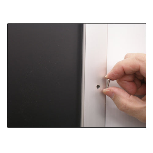 REMOVE SECURITY SCREWS FROM THE FRAME PROFILE TO REPLACE POSTERS 28 x 44